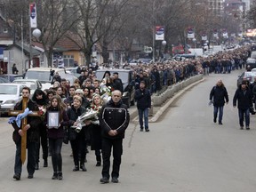 People follow the casket during a final farewell of Kosovo Serb politician Oliver Ivanovic in the northern, Serb-dominated part of Mitrovica, Kosovo, Wednesday, Jan. 17, 2018. Ivanovic's body will be transferred to the Serbian capital, Belgrade, where he will be buried on Thursday. Ivanovic was gunned down Tuesday morning in the northern Kosovo city of Mitrovica.