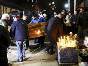 People carry the coffin of Kosovo Serb politician Oliver Ivanovic in front of his office in the northern, Serb-dominated part of Mitrovica, Kosovo, Tuesday, Jan. 16, 2018. Ivanovic was gunned down Tuesday morning in the northern Kosovo city of Mitrovica.