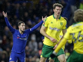 Chelsea's Eden Hazard, left, reacts during the English FA Cup third round replay between Chelsea and Norwich City at the Stamford Bridge, in London, Wednesday, Jan. 17, 2018.
