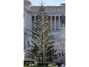 This photo taken on Dec. 19, 2017 shows, Rome's official Christmas tree standing in front of the Unknown Soldier monument in downtown Rome. Rome's city cabinet decided on the tree's "new life" Tuesday, Jan. 9, 2018, hoping to close an embarrassing chapter that saw the tree, so droopy and dried out it was nicknamed "Mangy" by Romans, come to symbolize the city's degradation and dysfunction under its 5-Star mayor, Virginia Raggi, and years of neglect and corruption before her.