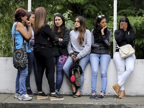 Women related to men who fought alongside the late, rebel police officer Oscar Perez wait for their loved ones' bodies to be turned over, outside the morgue in Caracas, Venezuela, Wednesday, Jan. 17, 2018. Seven people died fighting against police and soldiers Monday in a small mountain community outside of Caracas, according to Interior Minister Nestor Reverol.