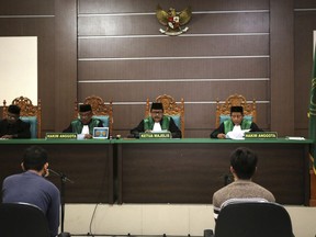 In this May 10, 2017 file photo, two men accused of having gay sex sit on the defendants' chairs during their trial at the Shariah Court in Banda Aceh, Indonesia. Riding a tsunami of moral conservatism and anti-gay prejudice, Indonesia's Islamic political parties appear on the cusp of a major victory: outlawing all sex outside marriage. Revisions to Indonesia's criminal code being considered by Parliament would allow prison sentences of up to five years for sex between unmarried people and also criminalize gay sex, the bugbear of Indonesia's Islamic and secular political parties.