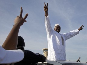 FILE- In this Thursday Jan. 26, 2017 file photo, Gambian President Adama Barrow greets the crowds after arriving at Banjul airport in Gambia. In the year since the world marvelled at the fall of African dictator Yahya Jammeh, the tiny nation of Gambia has risen from the shadows of his "rule of fear" with its arbitrary arrests, enforced disappearances and extrajudicial killings. ﻿﻿