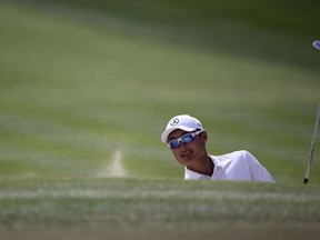 China's Li Haotong plays a bunker on the 1st hole during the final round of the Dubai Desert Classic golf tournament in Dubai, United Arab Emirates, Sunday, Jan. 28, 2018.