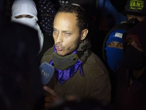 FILE - In this July 13, 2017 file photo, Oscar Perez speaks to the press at a night vigil to honor the more than 90 people killed during three months of anti-government protests, in Caracas, Venezuela. Officials in Venezuela have buried Perez killed nearly a week ago in a shootout with government security forces. Family members said only two of Oscar Perez's relatives were permitted to observe the tightly controlled burial on Sunday, Jan. 21, 2018.