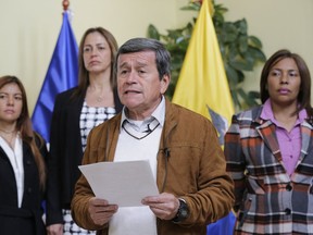 FILE - In this Jan. 10, 2018 file photo, Pablo Beltran, representative of the National Liberation Army, known by its Spanish acronym ELN, reads a statement at the end of a round of peace talks with the Colombian government in Quito, Ecuador. Colombian President Juan Manuel Santos on Monday, Jan. 29, 2018 suspended peace talks with the country's last remaining rebel group after a series of bombings over the weekend killed seven police officers.