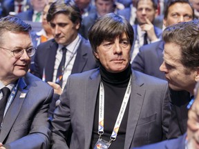 Joachim Loew, center,  head coach of the German national soccer team, attends the soccer UEFA Nations League draw, at the SwissTech Convention Center, in Lausanne, Switzerland, Wednesday, Jan. 24, 2018.
