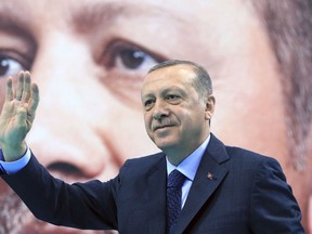 Turkey's President Recep Tayyip Erdogan waves to supporters of his ruling Justice and Development Party (AKP), at a rally in Elazig, eastern Turkey, Saturday, Jan. 13, 2018. Erdogan has said Turkey will oust Kurdish militants from Afrin, northern Syria, as the military shelled the area from across the border. Turkey considers the YPG a terror group and an extension of the Kurdish insurgency within its own borders. (Pool Photo via AP)