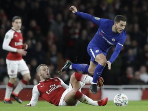 Arsenal's Jack Wilshere, left, challenges for the ball with Chelsea's Eden Hazard during the English League Cup semifinal second leg soccer match between Chelsea and Arsenal at the Emirates stadium in London, Wednesday, Jan.24, 2018.