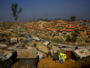 A Rohingya refugee puts up a blanket for drying at Balukhali refugee camp 50 kilometres (32 miles) from, Cox's Bazar, Bangladesh Tuesday, Jan. 23, 2018. Myanmar says it's ready for a gradual repatriation of Muslim Rohingya refugees chased out by the Buddhist-majority country's military. Bangladesh says it's preparing for the transfer, but it might need more time as more than 680,000 Rohingya Muslims are now living in sprawling and squalid refugee camps in Bangladesh.