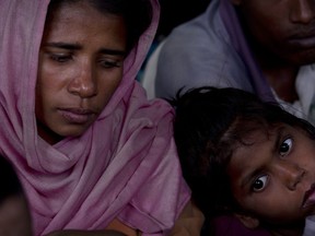 A newly arrived Rohingya family waits at a temporary shelter before their registration at Nayapara refugee camp, some 69 kilometres (43 miles) from in Cox bazar, Bangladesh, Saturday, Jan. 13, 2018. In Rakhine state of Myanmar, government troops have been accused of "ethnic cleansing" that has forced more than 655,000 of Rohingya Muslims to flee into Bangladesh, out of which 60 per cent of the refugees are children.