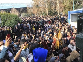 In this photo taken by an individual not employed by the Associated Press and obtained by the AP outside Iran, university students attend a protest inside Tehran University while anti-riot Iranian police prevent them to join other protestors, in Tehran, Iran, Saturday, Dec. 30, 2017. A wave of spontaneous protests over Iran's weak economy swept into Tehran on Saturday, with college students and others chanting against the government just hours after hard-liners held their own rally in support of the Islamic Republic's clerical establishment. (AP Photo)