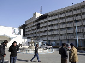 People stand outside the Intercontinental Hotel in Kabul, Afghanistan, Tuesday, Jan. 23, 2018. Survivors of the Taliban attack on Kabul's Intercontinental Hotel gave harrowing accounts on Monday of the 13-hour weekend standoff. The siege ended on Sunday with Afghan security forces saying they had killed the last of six Taliban militants who stormed the hotel in suicide vests late the previous night, looking for foreigners and Afghan officials to kill.