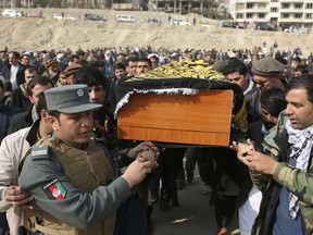 Men carry the coffin of a relative who died in Saturday's deadly suicide attack in Kabul, Afghanistan, Sunday, Jan. 28, 2018. The deadly explosion caused by a suicide bomber driving an ambulance in the capital.