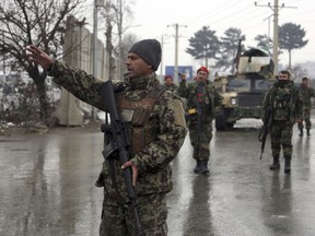 Afghan national army soldiers stand guard at the entrance gate of the Marshal Fahim military academy in Kabul, Afghanistan, Monday, Jan. 29, 2018. Militants attacked an Afghan army unit guarding the military academy on Monday, officials said. Hours later, the Islamic State group claimed responsibility for the assault.