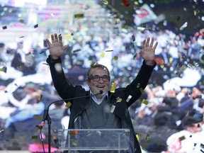 Former rebel leader Rodrigo Londono, known as Timochenko, salutes at an event to present candidates running for Congress for the political party formed by former guerrillas of the Revolutionary Armed Forces of Colombia, FARC, in Bogota, Colombia, Saturday, Jan. 27, 2018.
