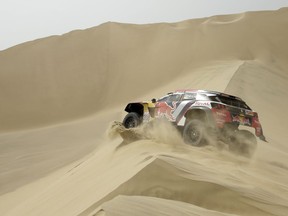 Driver Cyril Despres, of France, and co-driver David Castera, of France, race their Peugeot during the first stage of the 2018 Dakar Rally between Lima and Pisco, Peru, Saturday, Jan. 6, 2018.