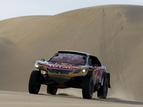 Driver Stephane Peterhansel, of France, and co-driver Jean Paul Cottret, of France, race their Peugeot during the 5th of the 2018 Dakar Rally between San Juan de Marcona and Arequipa, Peru, Wednesday, Jan. 10, 2018.