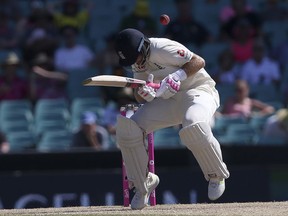 England's Joe Root avoids a bouncer from Australia's Pat Cummins during the fourth day of their Ashes cricket test match in Sydney, Sunday, Jan. 7, 2018.