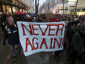 Protesters walk during a demonstration against the new Austrian government in Vienna Austria, Saturday, Jan. 13, 2018.