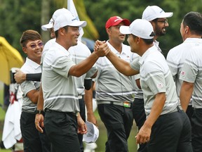 Hideto Tanihara of Japan, left, and Kang Sung-hoon of South Korea, right, celebrate winning the foursome matches during the 2018 EurAsia Cup golf tournament at Glenmarie Golf & Country Club in Shah Alam, Malaysia, Saturday, Jan. 13, 2018.