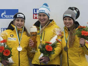 From left: Second placed Tina Hermann, winner Jacqueline Loelling, and third placed  Anna Fernstaedt, all from Germany,  celebrate on the podium after the women's skeleton World Cup race in Altenberg, Germany, Friday, Jan. 5, 2018.