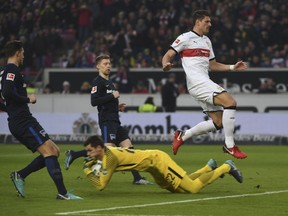 Stuttgart's Mario Gomez, right, challenges with Berlin players, goalie Rune Jarstein, second right, Mitchell Weiser, center, and Niklas Stark during the German Bundesliga soccer match between VfB Stuttgart and Hartha BSC Berlin, in Stuttgart, Germany, Saturday, Jan. 13, 2018.