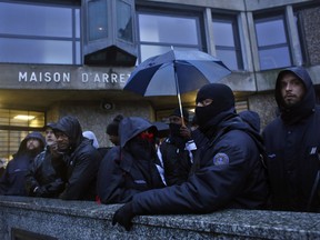 Prison staff demonstrate outside Fleury Merogis prison in Fleury Merogis, south of Paris, Monday Jan. 22, 2018. Scores of unionized prison guards working at Europe's largest prison, Fleury-Mergois prison, along with others were demanding more security, more resources and safer handling of violent inmates.