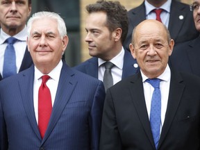 U.S. Secretary of State Rex Tillerson, left, and French Foreign Minister Jean-Yves Le Drian, pose for a photo during a foreign ministers' meeting on the International Partnership against Impunity for the Use of Chemical Weapons, in Paris, Tuesday, Jan. 23, 2018. The United States and 28 other countries are launching a new plan to better identify and punish anyone who uses chemical weapons, amid new reports of a suspected chemical attack in Syria.