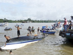 Indonesia rescue team search victims a boat that capsized off Indonesia's part of Borneo island on Monday, Jan. 1, 2018. A search and rescue official in Tarakan, said that in addition to at least 8 deaths, several other people were believed to be missing.