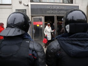 Policemen guard outside a metro station before a rally in Moscow, Sunday, Jan. 28, 2018. Opposition politician Alexey Navalny calls for nationwide protests following Russia's Central Election Commission's decision to ban his presidential candidacy.