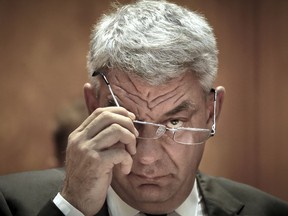 FILE - In this Thursday, June 29, 2017, file photo Romanian Premier Mihai Tudose removes his glasses before a parliament vote on the new Romanian government in Bucharest, Romania. Romania's prime minister has resigned, Monday, Jan. 15, 2018, after his party withdrew its support amid a power struggle with party chairman after Romania's ruling left-wing Social Democratic Party withdrew its support for Mihai Tudose after a meeting lasting more than five hours.