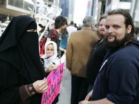 Zaynab Khadr, left, and Joshua Boyle protest in front of the Metro Convention centre in Toronto on Friday May 29, 2009. (Jim Ross / Canadian Press)