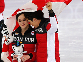 Tessa Virtue and Scott Moir celebrate Canada's figure skating team event gold medal.