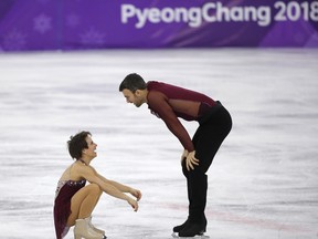 Canada's Meagan Duhamel and Eric Radford react to their performance.
