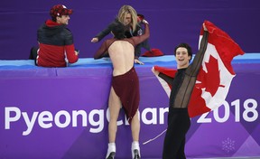 Tessa Virtue and Scott Moir celebrate their gold medal win in the ice dance free.