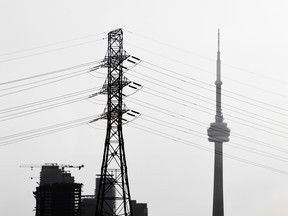 An electrical tower with the CN Tower in the background in the city of Toronto, Wednesday September 20, 2017.