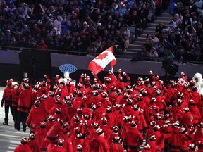 In this Feb. 7, 2014 file photo, Canadian athletes march in the opening ceremony at the Sochi Olympics.