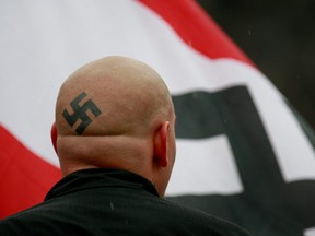 Neo-Nazi protestors organized by the National Socialist Movement demonstrate near where the grand opening ceremonies were held for the Illinois Holocaust Museum and Education Center on April 19, 2009 in Skokie, Illinois.