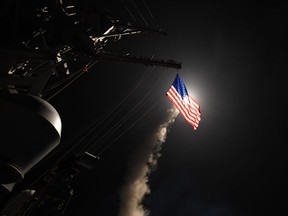 In this handout provided by the U.S. navy, the guided-missile destroyer USS Porter fires a Tomahawk land attack missile on April 7, 2017 in the Mediterranean Sea.
