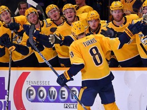 Kyle Turris of the Nashville Predators is congratulated by teammates after scoring a shootout goal against the Montreal Canadiens