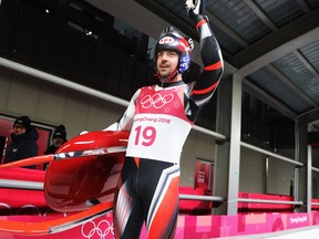 Sam Edney of Canada waves to the crowd following his fourth run in the men's luge competition at the 2018 Winter Olympics on Feb. 11, 2018.