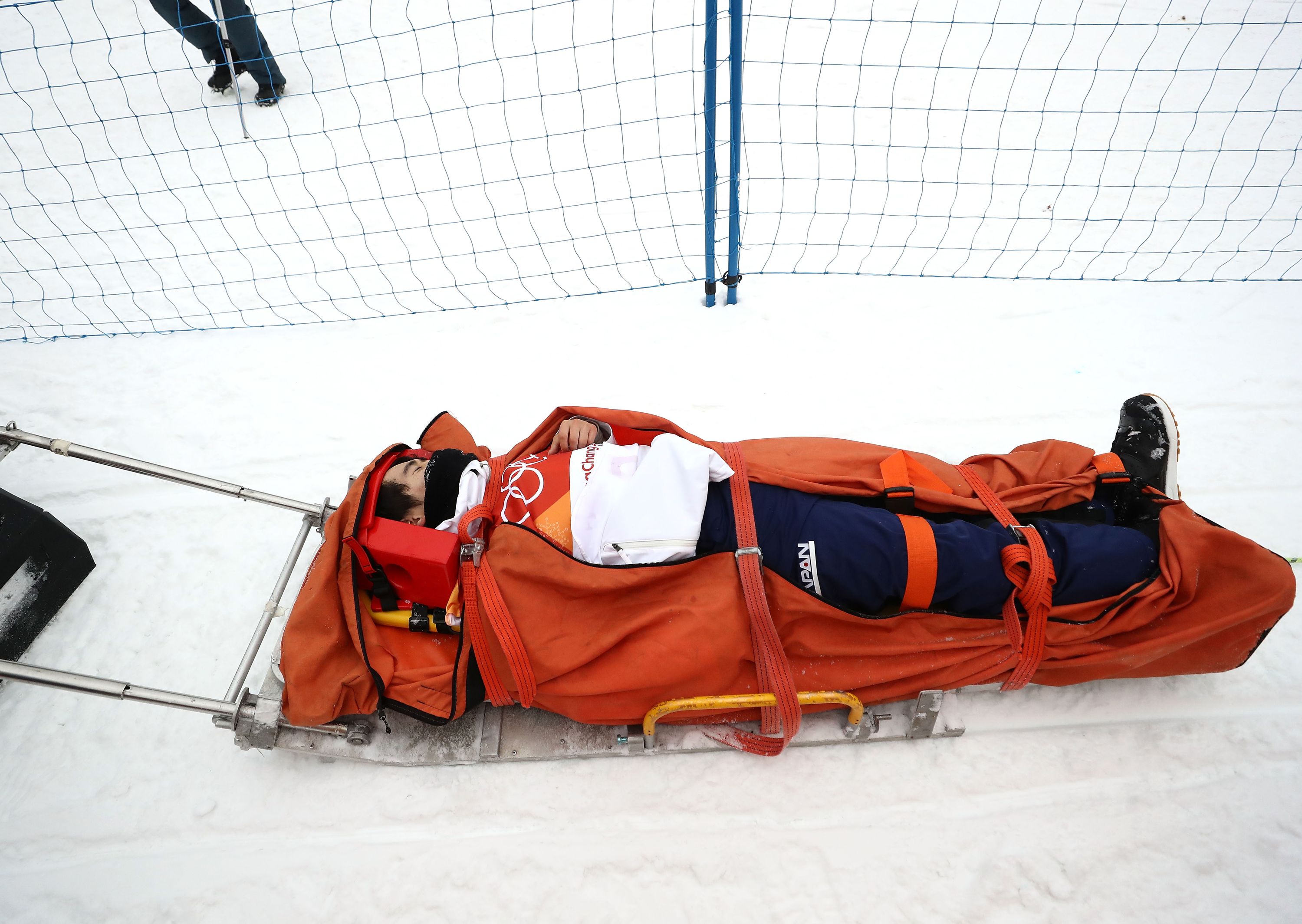 Yuto Totsuka of Japan is attended to by medical staff after crashing during the Snowboard Men&rsquo;s Halfpipe Final.