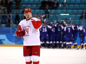 Alexander Barabanov of the Olympic Athlete from Russia skates away as Slovakia celebrates its 3-2 victory on Feb. 14, 2018 in Gangneung, South Korea.