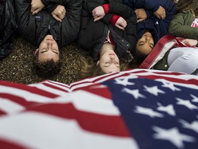Demonstrators on the ground during a "lie-in" demonstration supporting gun control reform near the White House on February 19, 2018 in Washington, DC.