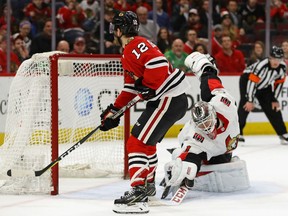 Alex DeBrincat of the Blackhawks scores a goal in the shootout against Mike Condon of the Ottawa Senators during their game Wednesday night at the United Center in Chicago. The Blackhawks won 3-2.