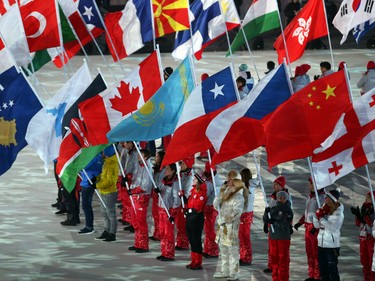 Kim Boutin of Canada brings in the Canadian flag during the closing ceremony of the PyeongChang 2018 Olympic Winter Games at the PyeongChang Olympic Stadium, February 25, 2018.   Photo by Jean Levac/Postmedia