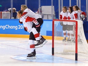 Canadian women's hockey players pose for photos at the Pyeongchang Olympics on Feb. 8.
