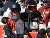 Spencer O’Brien (L) of Canada holds back her tears after a disappointing last final run in the women’s slopestyle event.