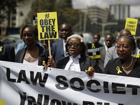 Mercy Wambua, center, the CEO of the Law Society of Kenya and other lawyers march to demand that court orders and the law are respected, following the government's deportation last week of an opposition politician in defiance of a court order that he be produced in court, in downtown Nairobi, Kenya Thursday, Feb. 15, 2018. A Kenyan judge Thursday rescinded the government orders used to deport to Canada the opposition politician Miguna Miguna over his alleged role in a mock inauguration by opposition leader Raila Odinga.